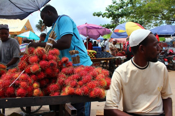 A man turns away from his booth selling rambutan, a spiked fruit that is eaten like a lychee. Photo by Gemina Garland-Lewis.